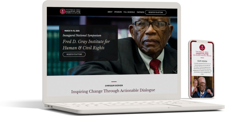 A laptop and smartphone display a website for the Fred D. Gray Institute for Human & Civil Rights. The site details an inaugural national symposium, featuring a photo of an older man in a suit.