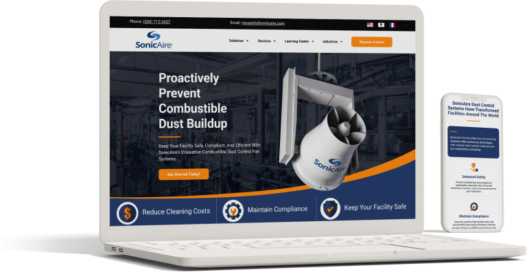 A laptop and smartphone display the SonicAire website homepage, featuring a dust control fan image, company logo, navigation menu, and calls to action about preventing combustible dust buildup.